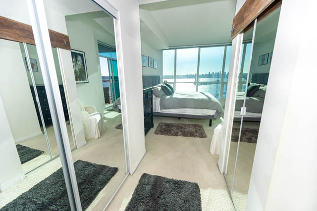 Bright bedroom with city view and modern furnishings. - 1905 - 138 East Esplanade Ave, North Vancouver