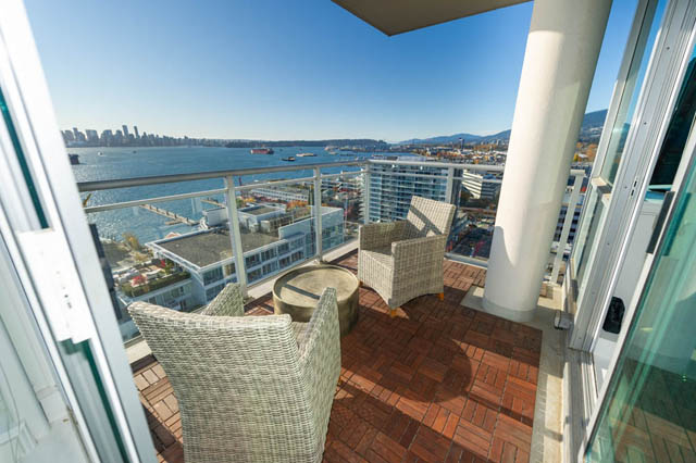 Bright balcony with city view, furnished seating, and wooden flooring. - 1905 - 138 East Esplanade Ave, North Vancouver