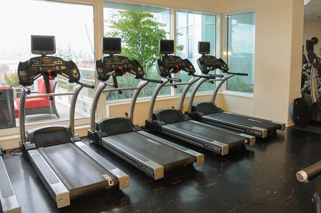 Bright gym with treadmills, city view, hardwood floors. - 1905 - 138 East Esplanade Ave, North Vancouver