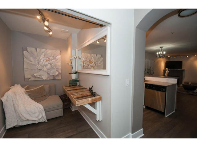 Furnished 1-bedroom + den with hardwood floors and a cozy bed setup. - 106 - 1868 W. 5th Avenue, Vancouver West Side