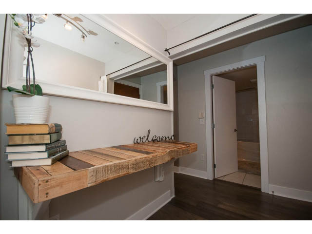 Furnished entryway with wooden floating shelves and hardwood floors. - 106 - 1868 W. 5th Avenue, Vancouver West Side