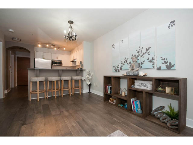 Bright kitchen with wooden floors, modern decor, and a cozy den area. - 106 - 1868 W. 5th Avenue, Vancouver West Side