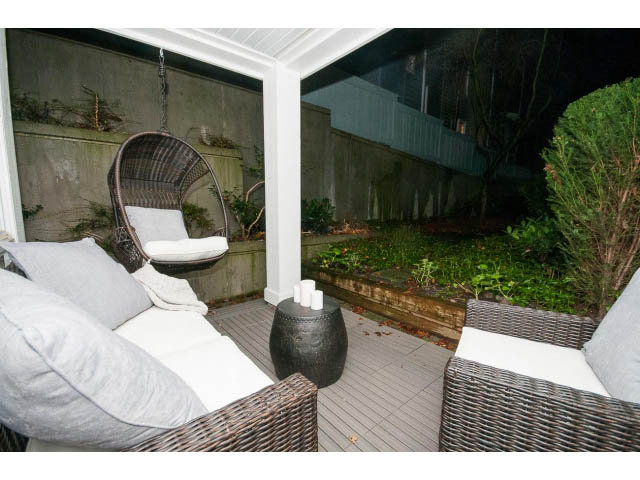 Furnished patio with wicker furniture and greenery. - 106 - 1868 W. 5th Avenue, Vancouver West Side