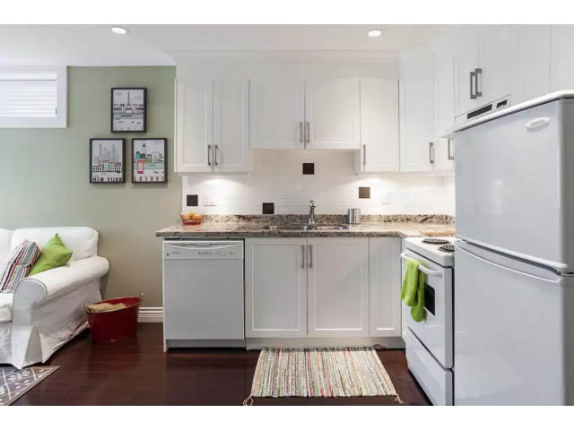 Bright kitchen with white cabinets, granite countertops, and hardwood floors. - 188 West 23rd Ave, Vancouver West Side
