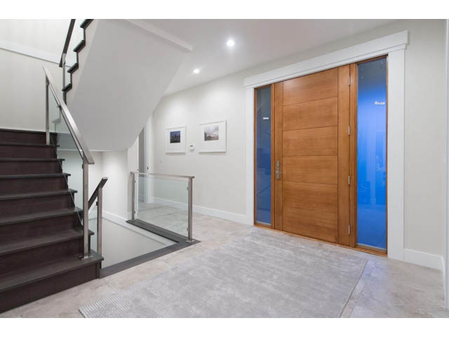 Foyer with wooden doors and glass panels, modern staircase, neutral tones. - 3192 Beverley Cres, North Vancouver