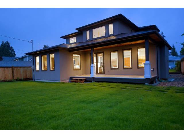 Spacious living room with modern design, large windows, and cozy lighting. - 3192 Beverley Cres, North Vancouver