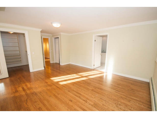 Spacious living room with hardwood floors and natural light. - 1145 Sutton Place, West Vancouver