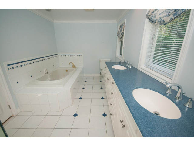 Spacious bathroom with blue speckled countertops and tiled floor. - 1145 Sutton Place, West Vancouver