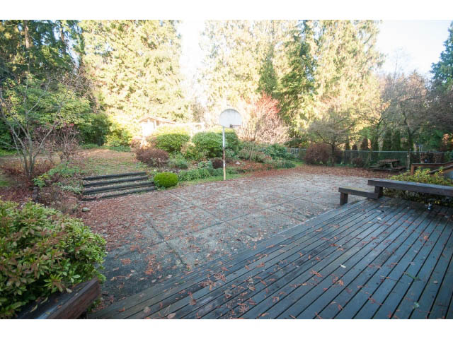 Furnished patio with wooden deck and garden view. - 1145 Sutton Place, West Vancouver