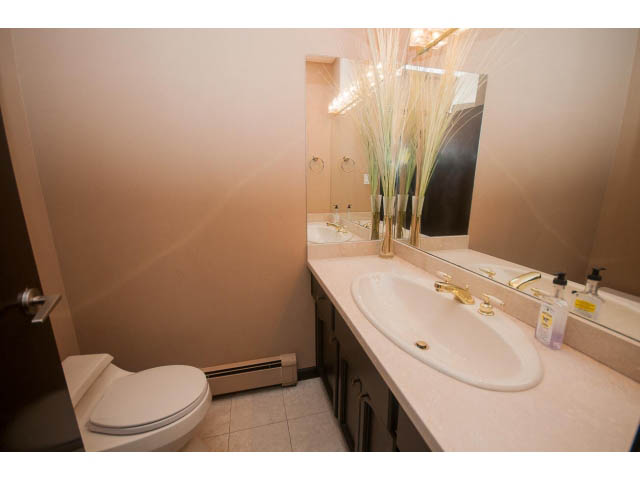 Bright bathroom with beige countertops and a modern sink. - 4251A Rockbank, West Vancouver