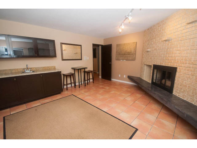 Spacious kitchen with dark cabinetry and tiled flooring. - 4251A Rockbank, West Vancouver
