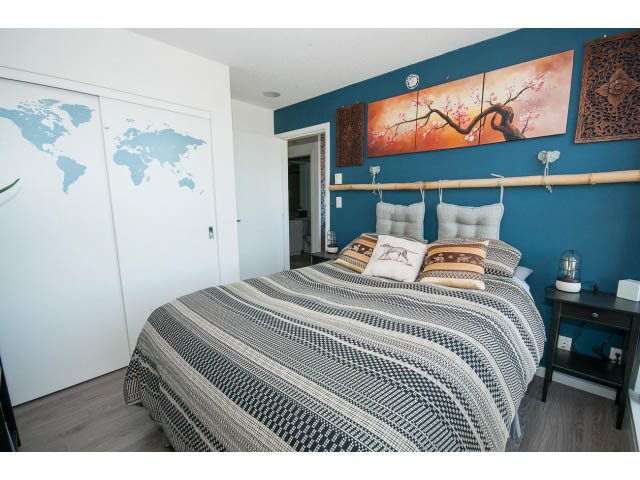 Furnished 1-bedroom condo with striped bedding, bamboo decor, and world map on wall. - 3105 - 602 Citadel Parade, Vancouver Downtown