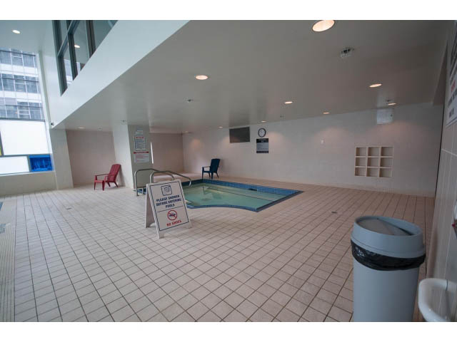Spacious living room with tiled floors, modern furnishings, and a large window view. - 3105 - 602 Citadel Parade, Vancouver Downtown