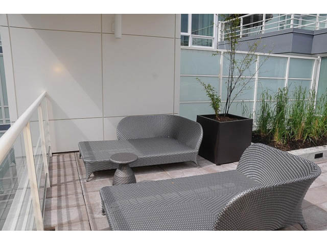 Furnished balcony with modern furniture and plants, overlooking cityscape. - 3105 - 602 Citadel Parade, Vancouver Downtown