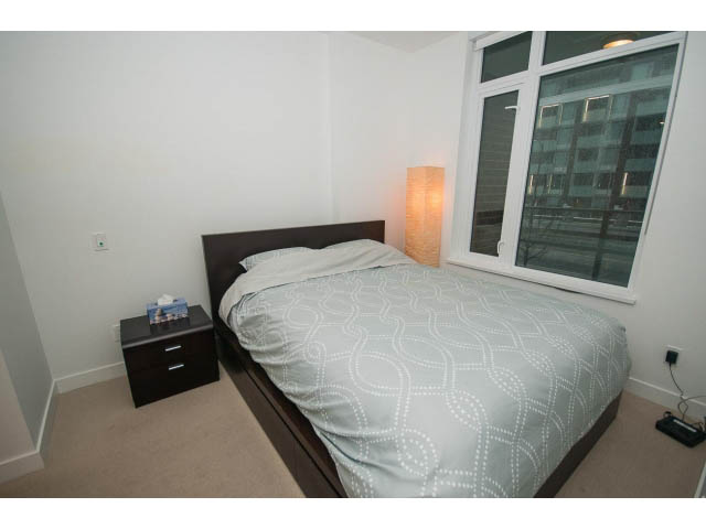 Bright bedroom with city view and modern decor. - 203 - 110 Switchmen St, Vancouver East Side