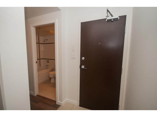 Furnished den with hardwood floors and a view of the bathroom. - 513 - 610 Granville Street, Vancouver Downtown