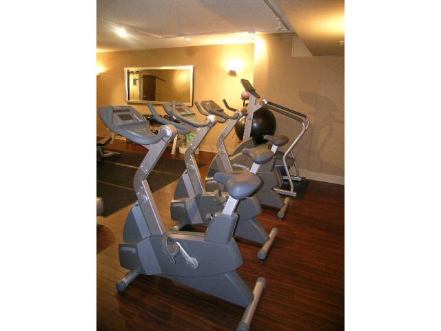 Bright gym with exercise bikes and a large mirror. - 513 - 610 Granville Street, Vancouver Downtown