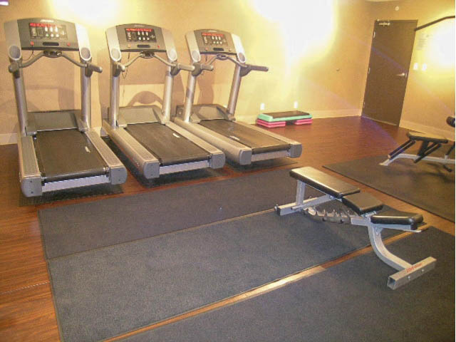 Fitness room with treadmills and exercise mats, hardwood floors. - 513 - 610 Granville Street, Vancouver Downtown