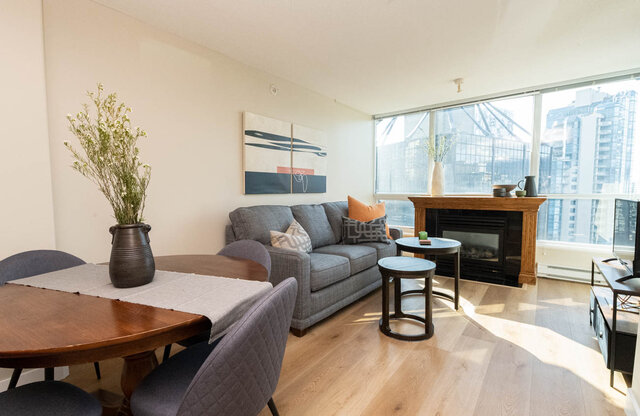 Spacious living room with hardwood floors, modern furniture, and a city view. - 2303 - 1328 West Pender Street, Vancouver Downtown