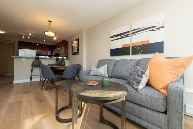 Spacious living room with modern decor, hardwood floors, and a stylish gray sofa. - 2303 - 1328 West Pender Street, Vancouver Downtown