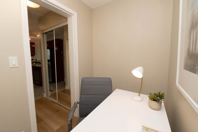 Furnished den with white countertop, modern lamp, and hardwood floors. - 2303 - 1328 West Pender Street, Vancouver Downtown