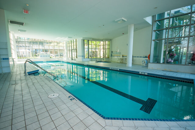 Spacious indoor pool area with tiled flooring and large windows, perfect for relaxation. - 2303 - 1328 West Pender Street, Vancouver Downtown