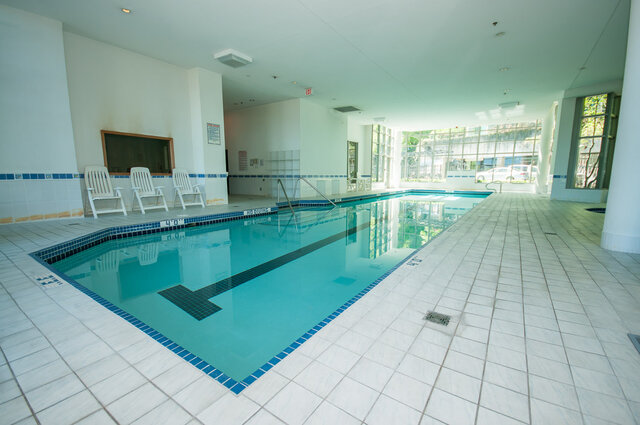 Spacious, well-lit indoor pool area with white tiles and natural light. - 2303 - 1328 West Pender Street, Vancouver Downtown