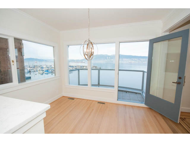 Bright kitchen with hardwood floors, city view, and modern chandelier. - 3655 Cameron Ave., Vancouver West Side