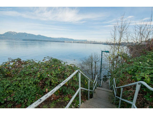 Stairway leading to a serene waterfront with city skyline in the distance. - 3655 Cameron Ave., Vancouver West Side