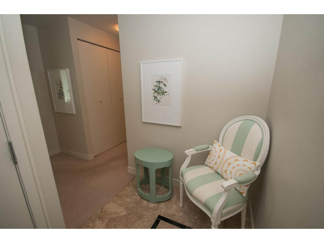Bright living room with mint green chairs and a framed botanical print. - 1402 - 1680 Bayshore Drive, Vancouver Downtown