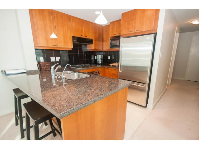 Bright kitchen with granite countertops, stainless steel appliances, and light wood cabinets. - 1402 - 1680 Bayshore Drive, Vancouver Downtown