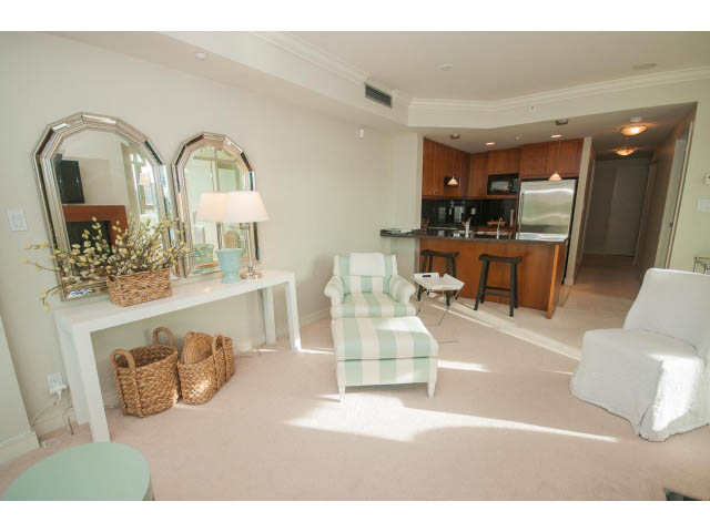 Bright living room with striped sofa, hardwood floors, and a city view. - 1402 - 1680 Bayshore Drive, Vancouver Downtown