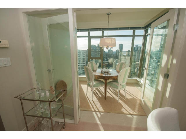Bright dining area with city view, glass table, and modern decor. - 1402 - 1680 Bayshore Drive, Vancouver Downtown