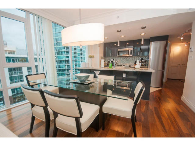 Bright dining area with city view, modern furnishings, and hardwood floors. - 605 - 133 E Esplanade, North Vancouver