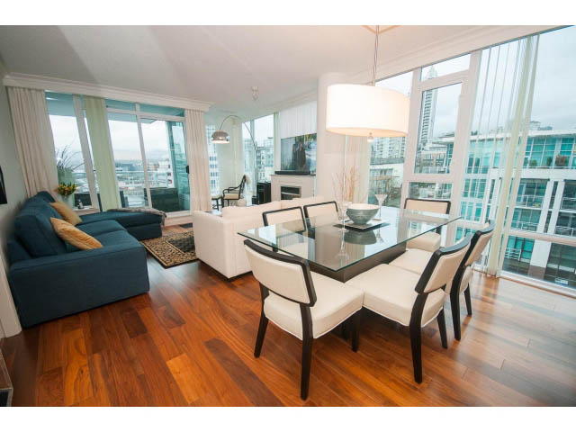 Spacious living and dining area with hardwood floors, city view, and modern furnishings. - 605 - 133 E Esplanade, North Vancouver