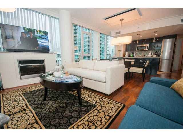 Spacious living room with hardwood floors, city view, and modern furnishings. - 605 - 133 E Esplanade, North Vancouver