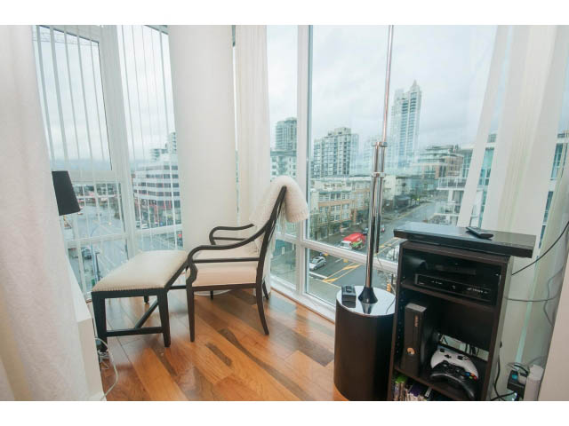 Bright living room with hardwood floors, city view, and modern furnishings. - 605 - 133 E Esplanade, North Vancouver