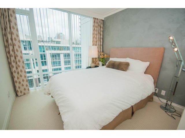 Spacious bedroom with a city view and modern furnishings. - 605 - 133 E Esplanade, North Vancouver