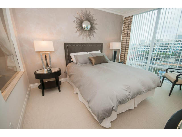 Spacious bedroom with king bed, city view, and modern decor. - 605 - 133 E Esplanade, North Vancouver