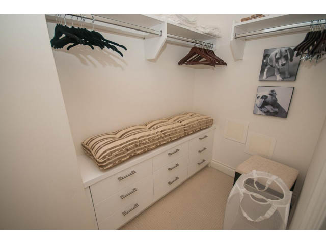 Furnished bedroom with white cabinets, countertop, and hangers. - 605 - 133 E Esplanade, North Vancouver