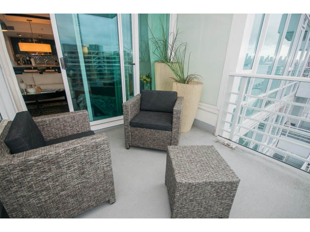 Furnished living room with modern furniture and city view. - 605 - 133 E Esplanade, North Vancouver