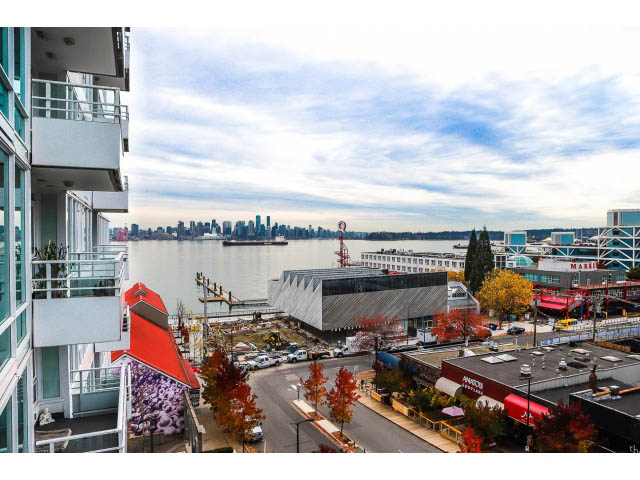 Furnished living room with city view and balcony access. - 605 - 133 E Esplanade, North Vancouver