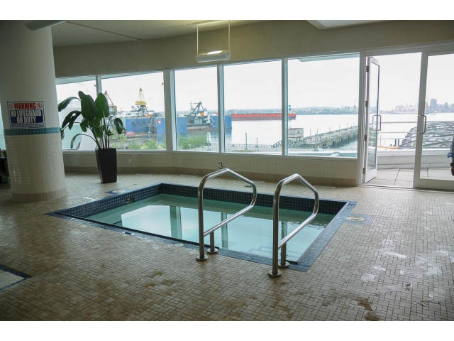 Spacious living room with large windows offering a stunning city view. - 605 - 133 E Esplanade, North Vancouver
