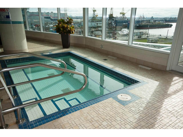 Spacious living room with large windows offering a stunning city view. - 605 - 133 E Esplanade, North Vancouver