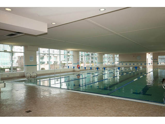 Spacious living room with large windows and city view. - 605 - 133 E Esplanade, North Vancouver