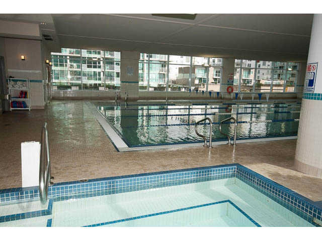 Spacious indoor pool area with city view and tiled floors. - 605 - 133 E Esplanade, North Vancouver