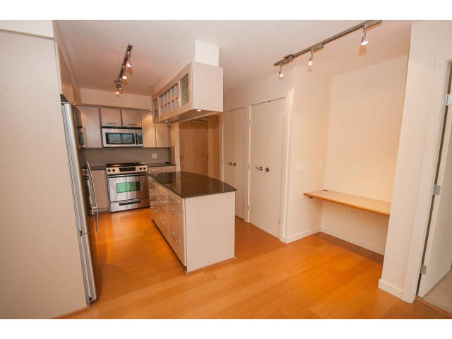 Bright kitchen with stainless steel appliances and hardwood floors. - 407 - 683 Victoria Park West, North Vancouver