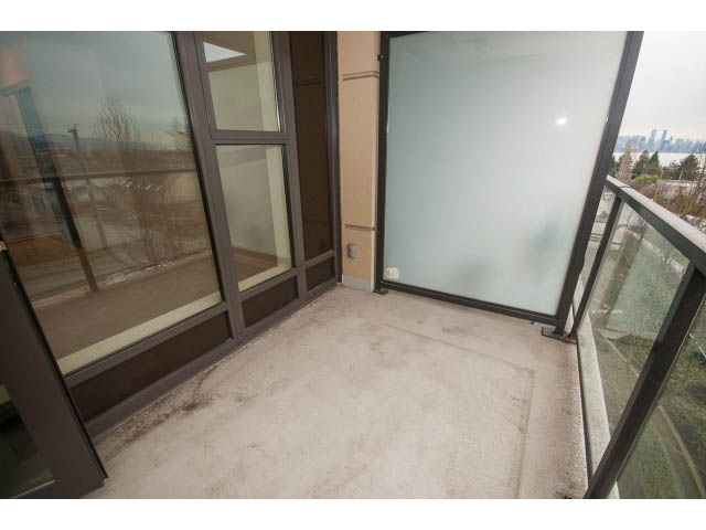 Furnished balcony with city view and glass doors. - 407 - 683 Victoria Park West, North Vancouver