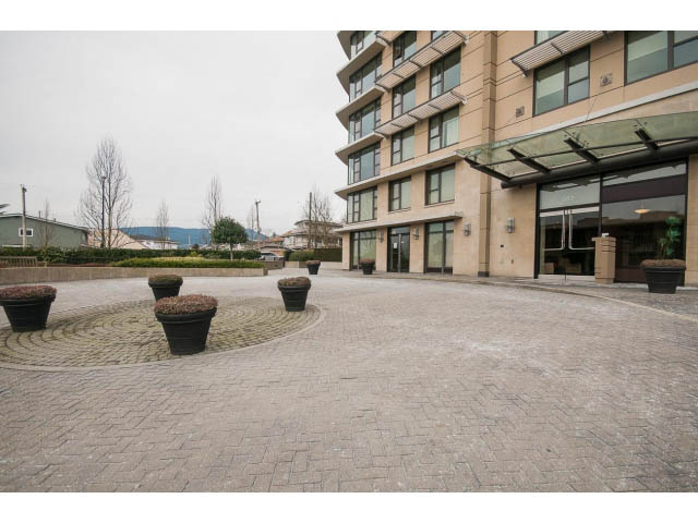 Spacious living room with modern decor and large windows. - 407 - 683 Victoria Park West, North Vancouver
