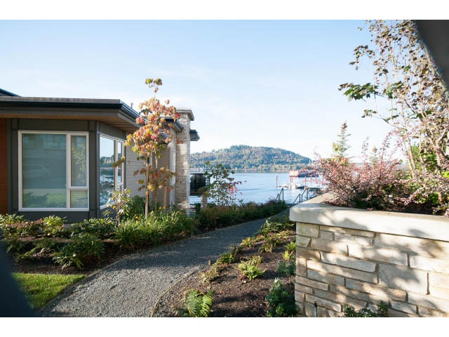 Furnished 2-bedroom + den condo with a serene lakeside view and modern landscaping. - 203 - 3825 Cate's Landing, North Vancouver